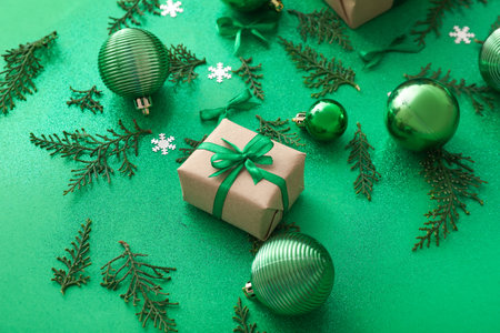 Composition with Christmas gift, decorations and thuja branches on color backgroundの写真素材