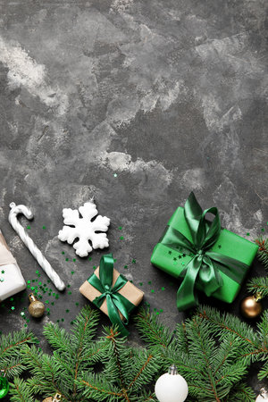 Composition with fir branches, Christmas gifts and decorations on dark backgroundの写真素材