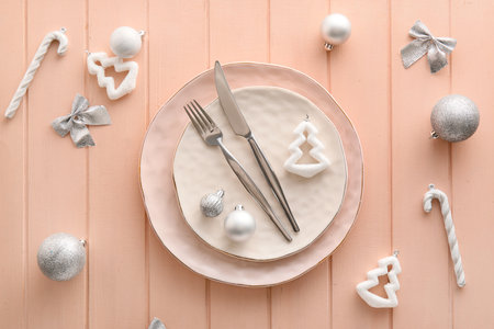Beautiful table setting with Christmas decor on pink wooden backgroundの写真素材