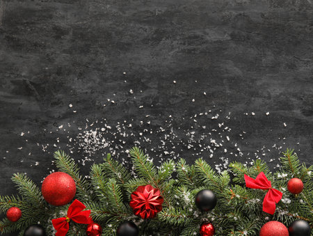 Christmas composition with fir branches and decorations on dark backgroundの写真素材