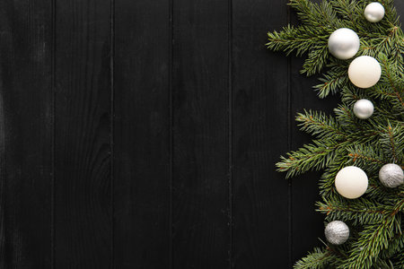 Fir branches with Christmas balls on dark wooden backgroundの写真素材
