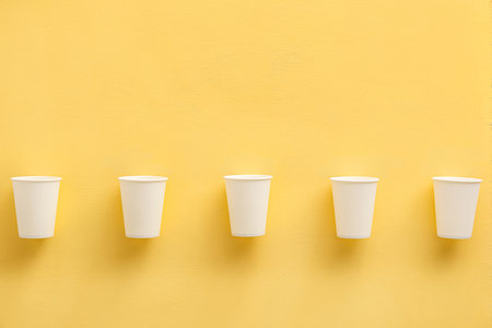 paper cups on yellow backgroundの写真素材