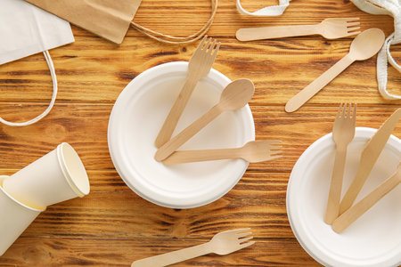 Eco tableware and different bags on wooden backgroundの写真素材