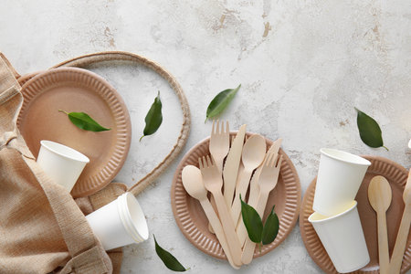 Tote bag with Eco tableware and plant leaves on light backgroundの写真素材