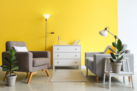 Interior of stylish living room with armchair, sofa and lampsの写真素材