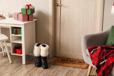 Santa boots near light door in roomの写真素材