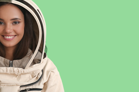 Female beekeeper on color backgroundの写真素材