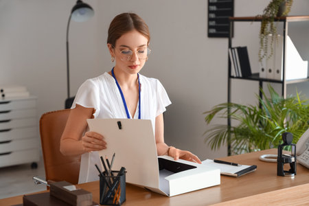 Female notary public working with documents in officeのeditorial素材