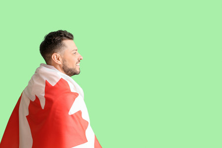Handsome man with flag of Canada on green backgroundの写真素材