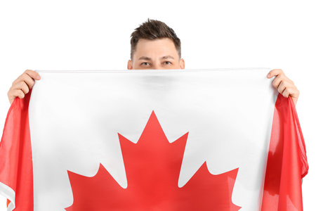Happy young man with flag of Canada on white backgroundの写真素材