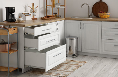 Counter with opened drawers in kitchen interiorの写真素材