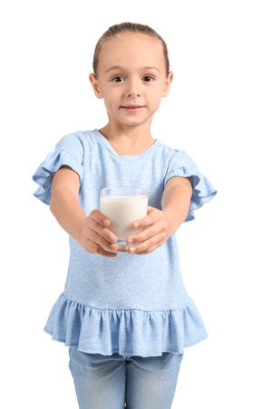 Little smiling girl holding glass of milk on white backgroundの写真素材
