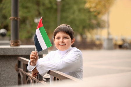 Cute little boy with national flag of UAE outdoorsの写真素材