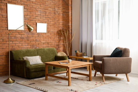 Interior of stylish living room with sofa, armchair and wooden coffee tablesの写真素材