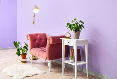 Interior of stylish living room with pink armchair, standing lamp and tableの写真素材