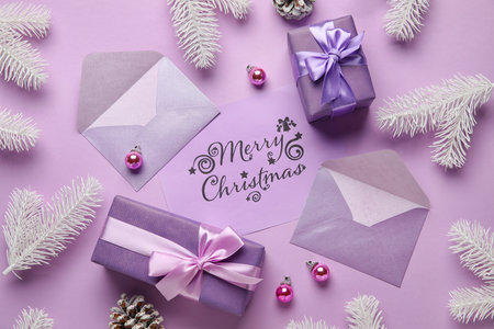 Christmas composition with greeting card, envelopes and gift boxes on lilac backgroundの写真素材