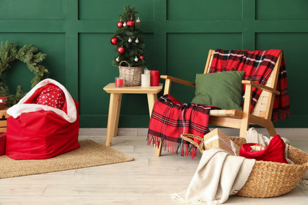 Stylish interior of modern living room with Santa bag, gifts and Christmas treeの写真素材