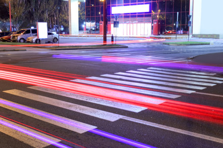 View of zebra crossing in city at nightの写真素材