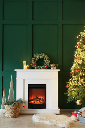 Interior of beautiful room with fireplace decorated for Christmasの写真素材