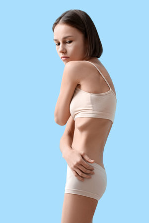 Young skinny woman on color background. anorexia conceptの写真素材
