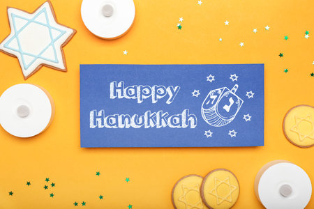 Different symbols of Hanukkah and greeting card on color backgroundの写真素材