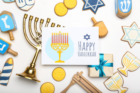 Different symbols of Hanukkah and greeting card on white backgroundの写真素材