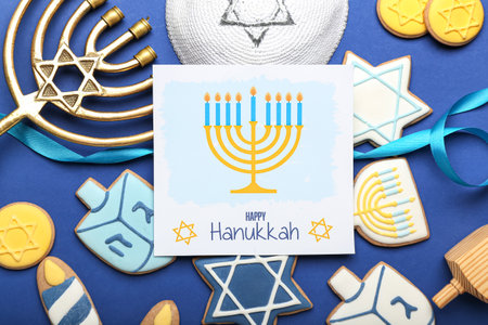 Different symbols of Hanukkah and greeting card on color backgroundの写真素材