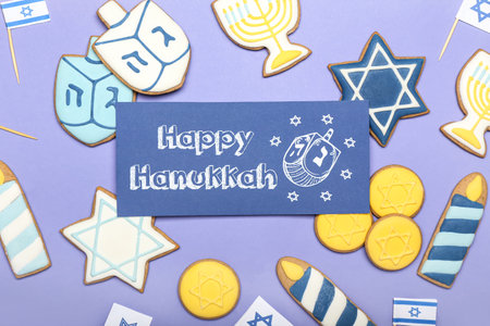 Tasty cookies and greeting card for Hanukkah on color backgroundの写真素材