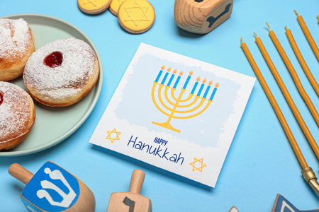 Different symbols of Hanukkah and greeting card on color backgroundの写真素材