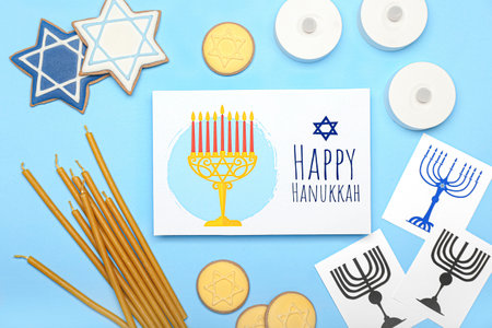 Different symbols of Hanukkah and greeting card on color backgroundの写真素材