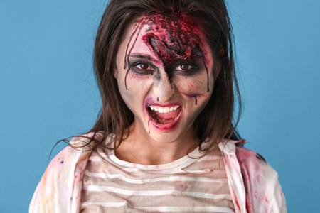 Scary zombie woman on color background