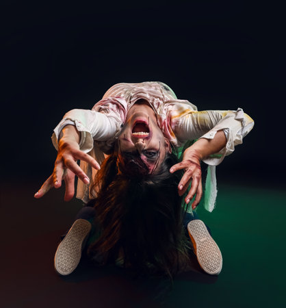 Scary zombie woman on dark backgroundの写真素材