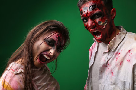 Scary zombies on color background