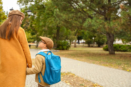 Woman walking her little son to schoolの写真素材