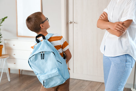 Mother getting her son ready for schoolの写真素材