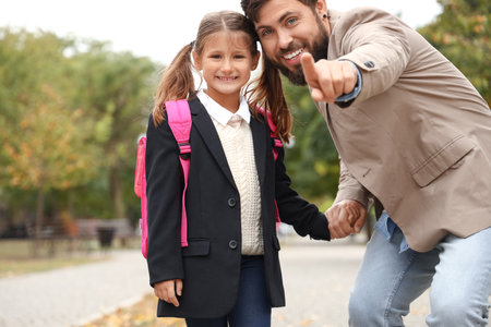 Man walking his little daughter to schoolの写真素材