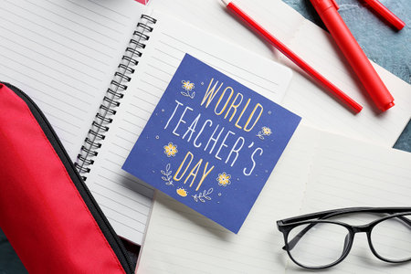 Concept of Teacher's Day. Greeting card and school supplies, top view