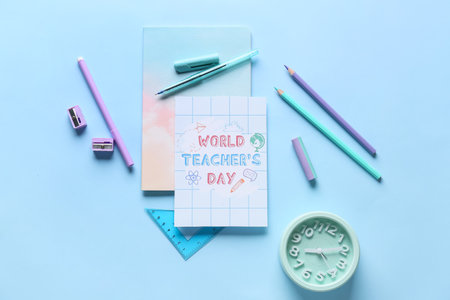 Concept of Teacher's Day. School supplies and greeting card on blue background, top view
