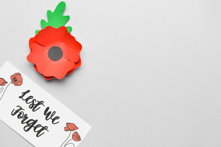 Remembrance Day in Canada. Red poppy flower and card on gray backgroundの写真素材
