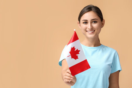 Young woman with national flag of Canada on color backgroundの写真素材