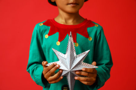 Little African-American boy with star on red background, closeupの写真素材