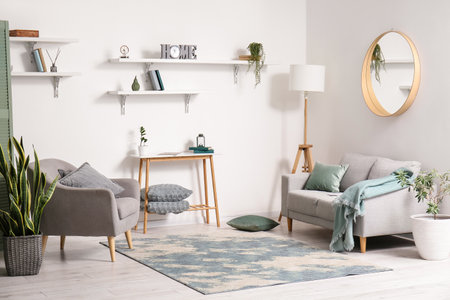 Interior of light living room with modern furniture and soft carpet
