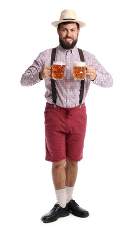 Handsome man in traditional German clothes and with beer on white backgroundの写真素材