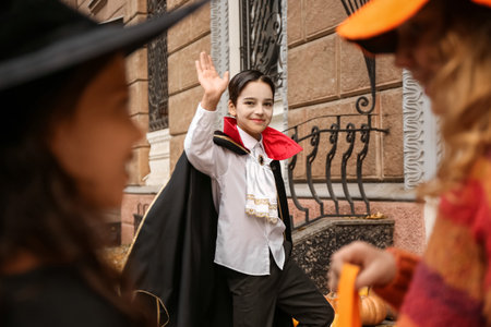 Cute little children in Halloween costumes outdoors
