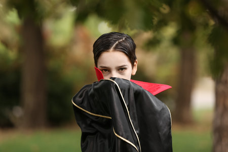 Cute little boy dressed as a vampire for Halloween outdoorsの写真素材