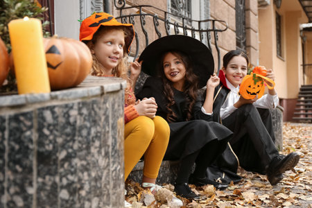Cute little children in Halloween costumes outdoorsの写真素材