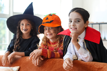 Cute little children celebrating Halloween at homeの写真素材