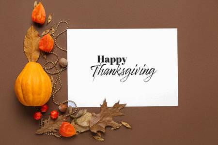 Autumn composition with pumpkin and text HAPPY THANKSGIVING on color backgroundの写真素材