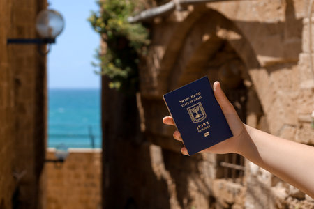 Woman with passport of Israel outdoors, closeupの写真素材