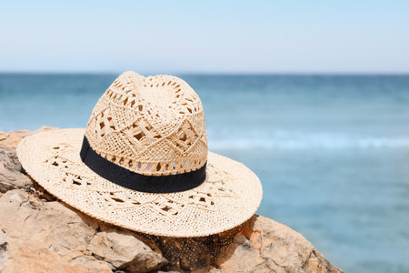 Stylish hat on rock near sea, closeupの写真素材